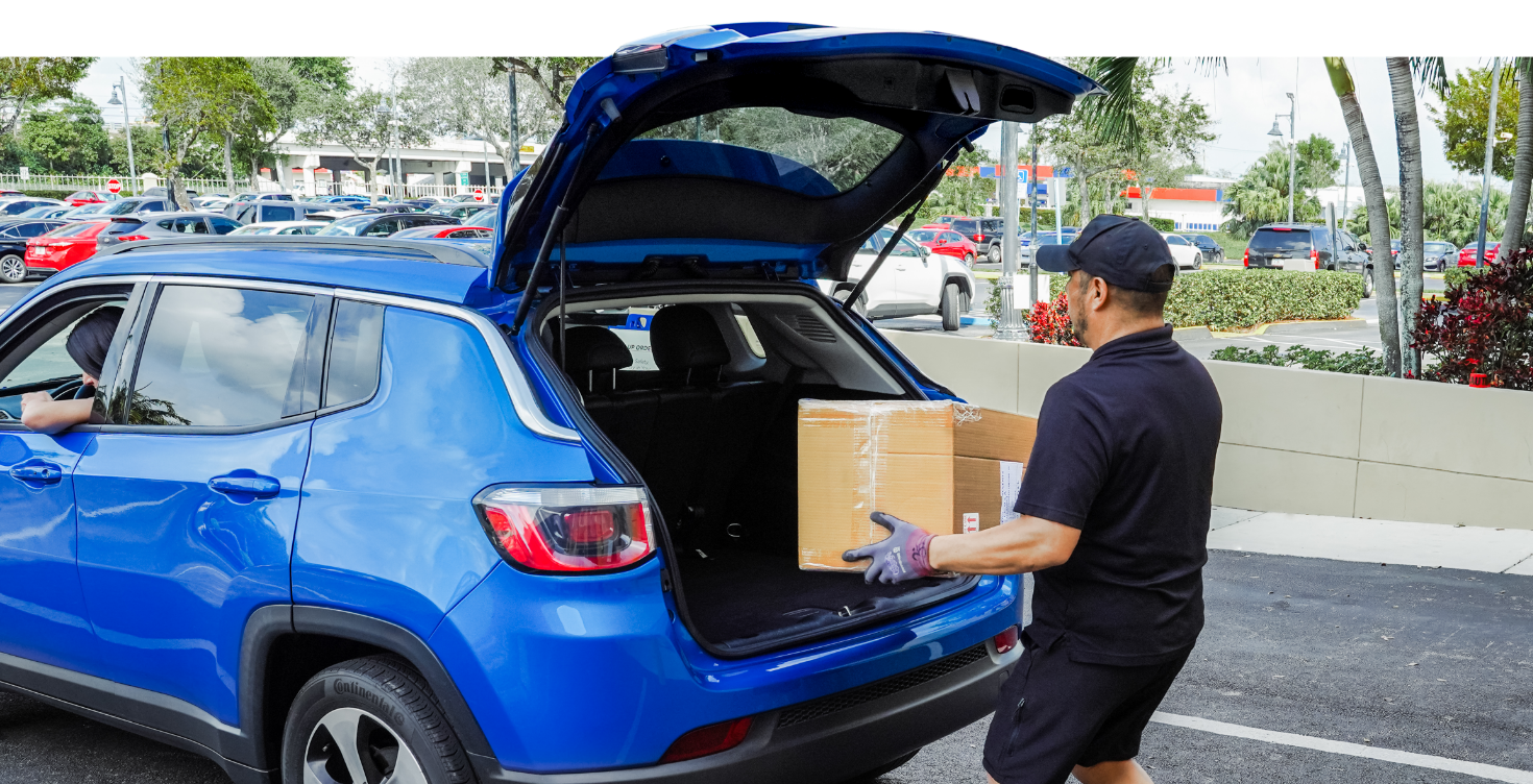 El Dorado Furniture associate loading a customer's order into the trunk of her car