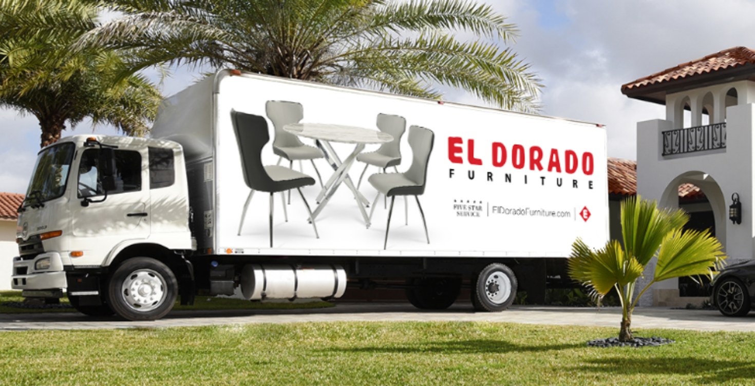 El Dorado Furniture delivery truck parked in front of a home